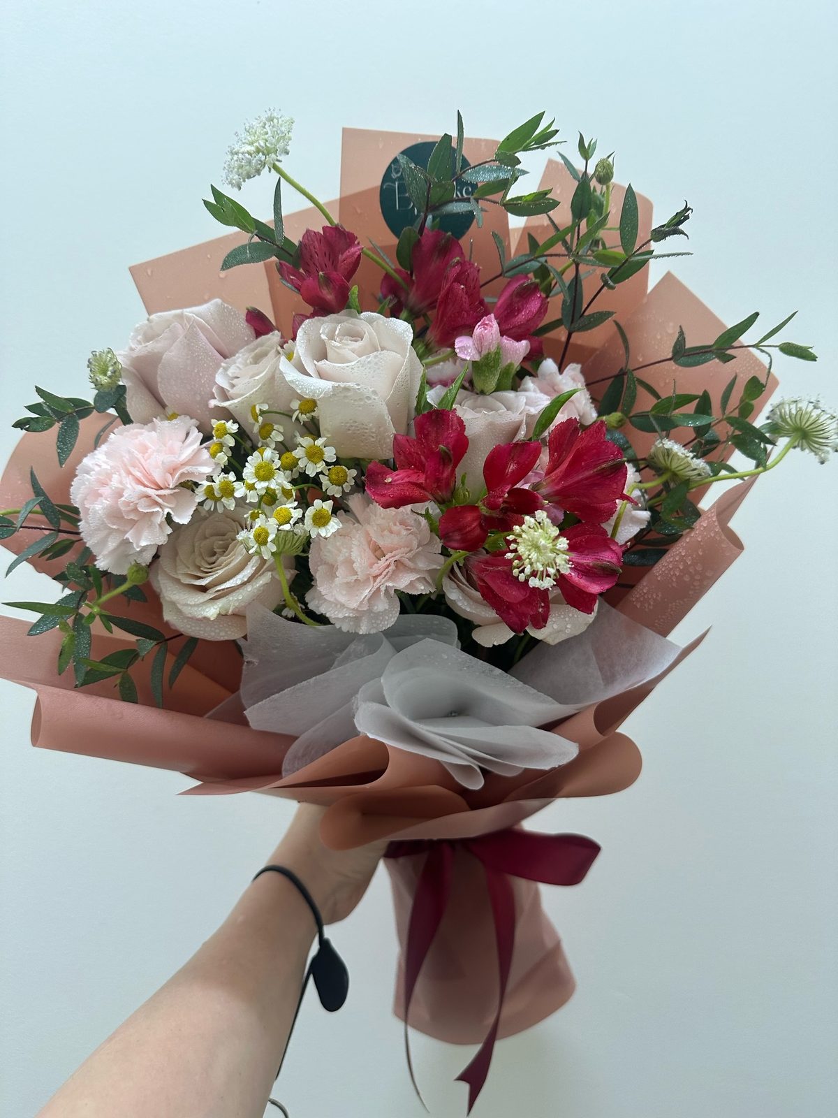 A hand-wrapped bouquet by Bespoke Blooms